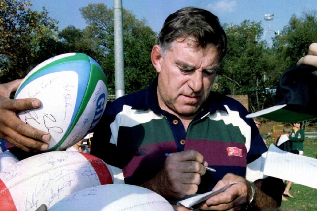 Colin Meads signs autographs for schoolchildren as the All Blacks visit Wanderers Stadium in Johannesburg, South Africa in 1995. Photo: Reuters