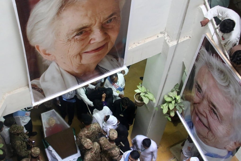 Pakistani soldiers stand guard beside the coffin containing body of Dr Ruth Pfau during her state funeral, in Karachi. Photo: EPA