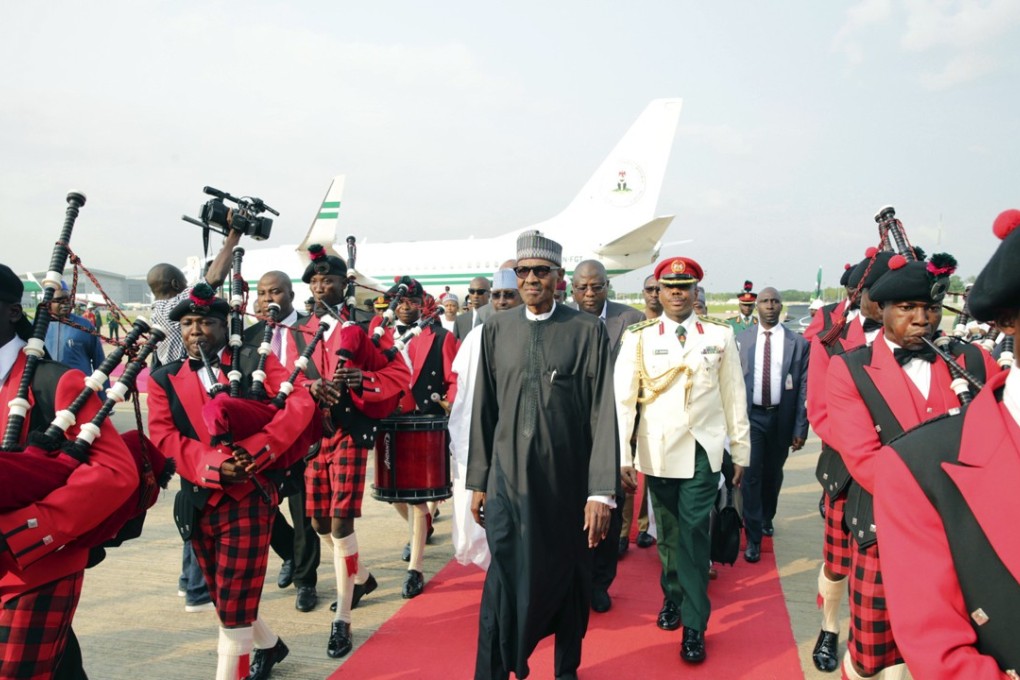 Nigeria President, Muhammadu Buhari, centre, walks upon his arrival at the Nnamdi Azikiwe airport in Abuja, Nigeria. Photo: AP