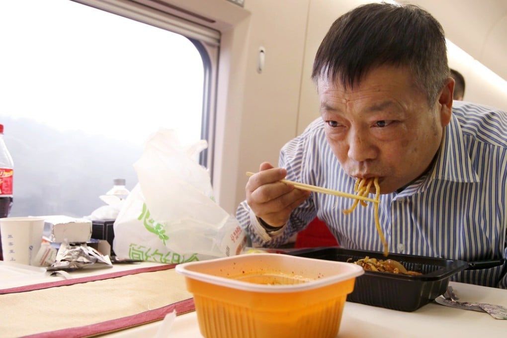 A man eats noodles served on a high-speed train from Guangzhou to Beijing. China’s demand for instant noodles has dropped 17 per cent over the past four years. Photo: Simon Song