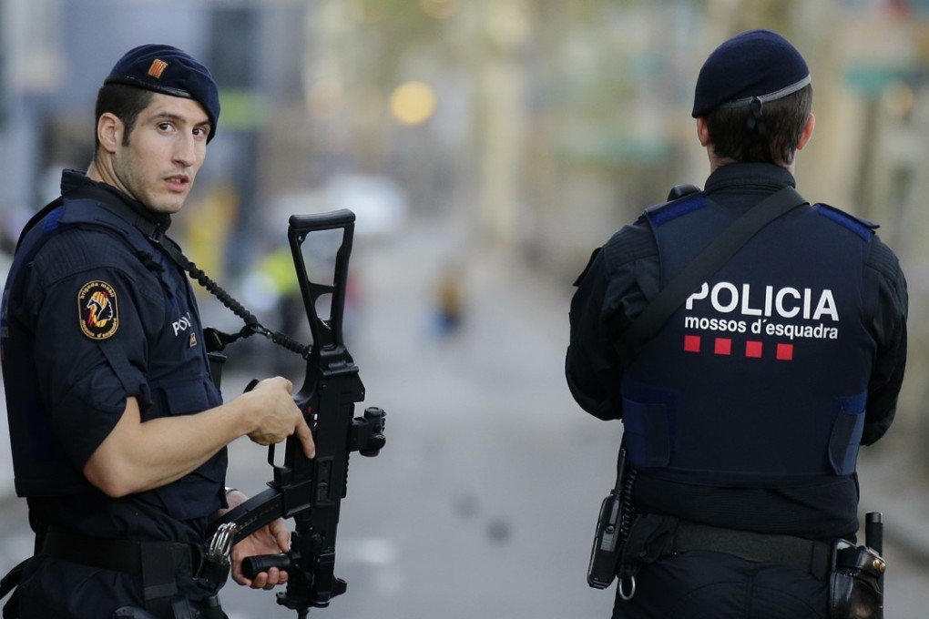 Armed police officer stand in Las Ramblas, Barcelona, Spain. Photo: AP