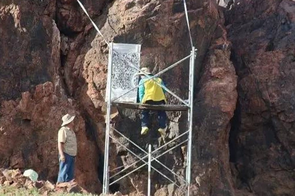 Researchers take rubbings of the ancient text from the Mongolian cliff face. Photo: Handout