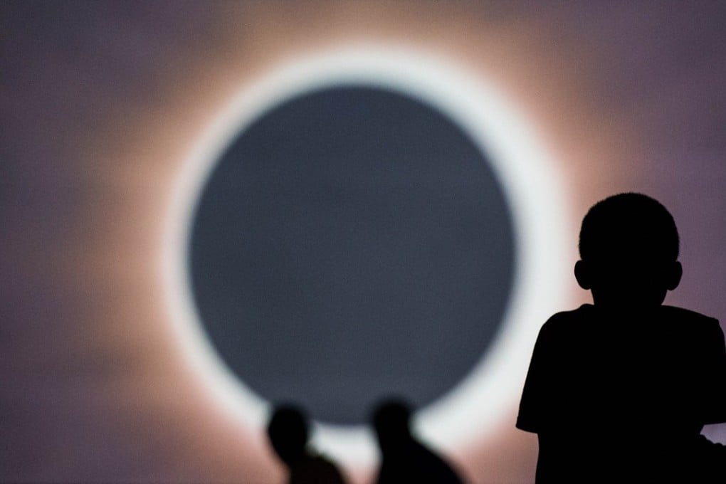 Children watch a presentation about the impending total eclipse during a drive-in movie at the Historic Columbia Speedway in Columbia, South Carolina, on Sunday. Photo: AFP