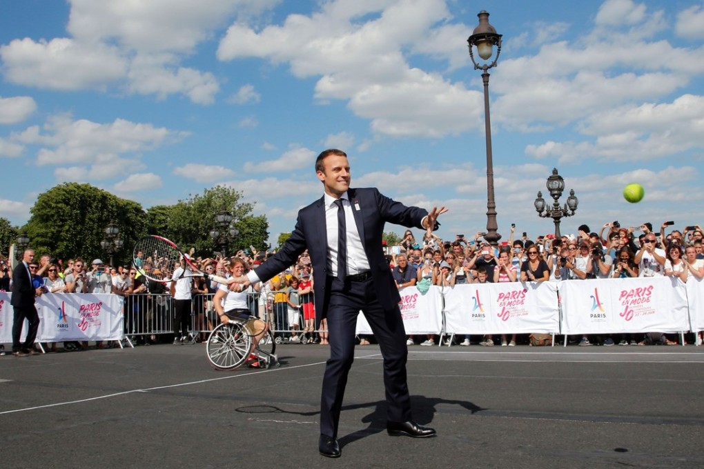 French President Emmanuel Macron plays tennis on the Alexandre III bridge near the Invalides in Paris in June to promote the city’s candidacy for the 2024 Summer Olympics. Photo: AFP