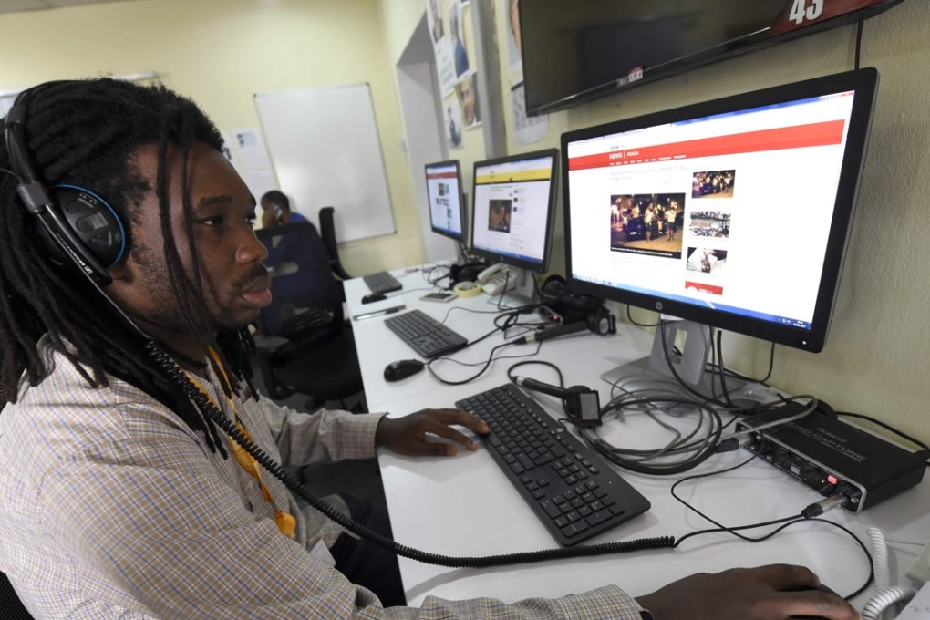 BBC programmer Busayo Iruemiode checks a website in Pidgin in Lagos, Nigeria, on Saturday. Photo: AFP