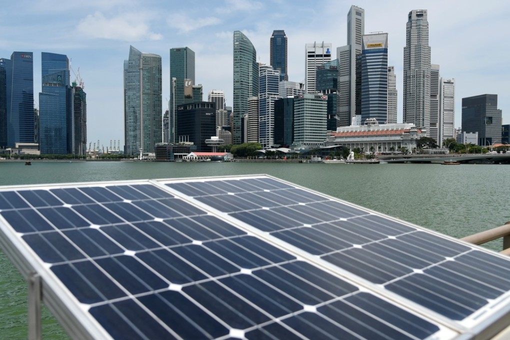 Solar panels used to power walkway lights are positioned along the Marina Bay overlooking the skyscrapers of Singapore in April last year. Singapore’s efficiency ratio on innovation is below the global average, and it is not a good example for Hong Kong to mirror. Photo: AFP