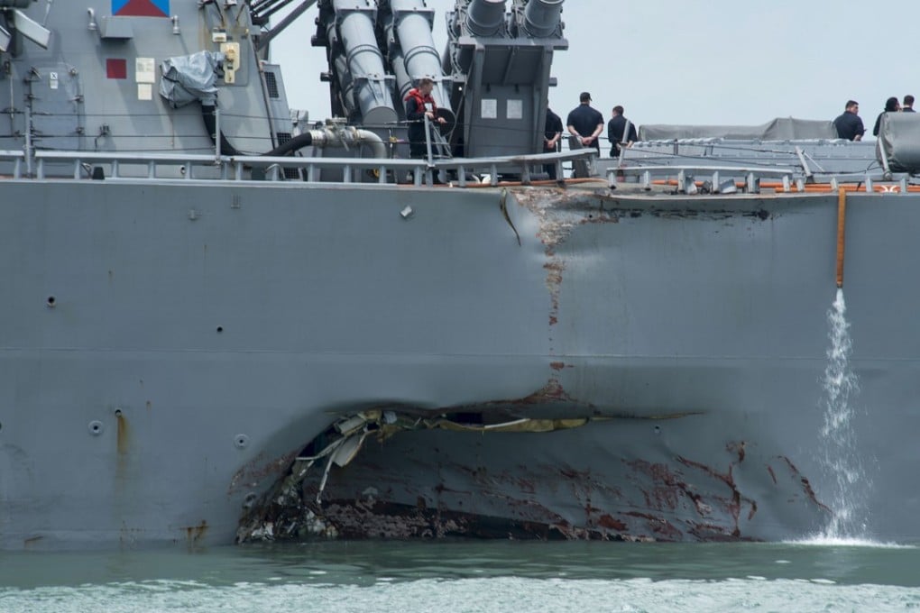 A massive hole can be seen at the waterline of the Arleigh Burke-class guided-missile destroyer USS John S. McCain at Changi Naval Base on Monday. Photo: TNS