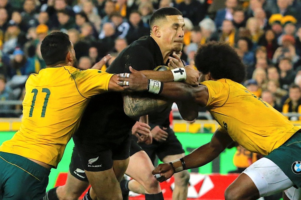 New Zealand’s Sonny Bill Williams is tackled by Australia’s Curtis Rona and Henry Speight. Photo: Reuters