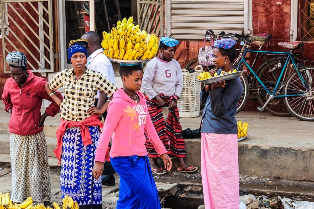 A woman in Tanzania balances a bunch of bananas on her head. A mob of 32 people were charged with murder for beating to death five Tanzanian woman they accused of being witches, a persistent problem in the African country. Photo: Shutterstock