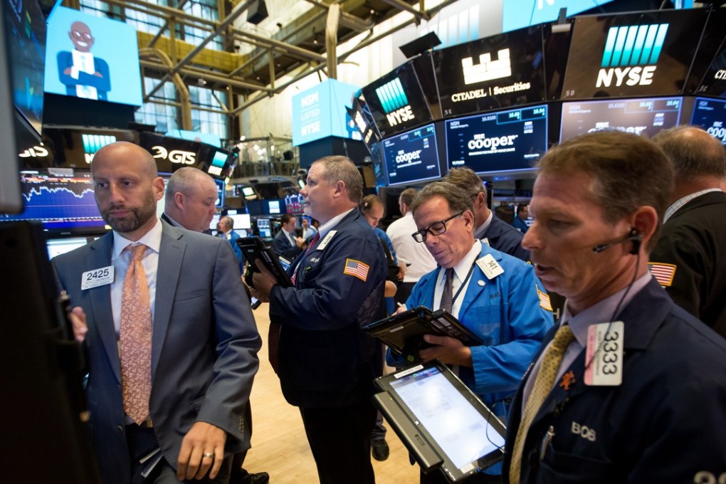Traders take down orders on the New York Stock Exchange as global stocks rallied on Tuesday. Photo: Bloomberg