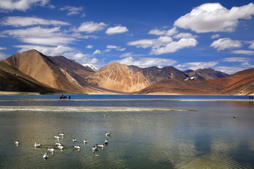 An Indian tourist rides a horse at the Pangong lake in the Ladakh region of India. Chinese soldiers hurled stones while attempting to enter the region on Tuesday but were confronted by Indian soldiers, a top police officer said, adding that neither side used guns. Photo: AP