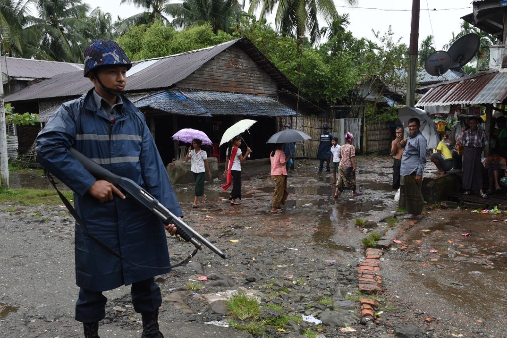 An armed policeman provides security during a visit by former UN secretary general Kofi Annan to Sittwe, Rakhine State. File photo: AFP