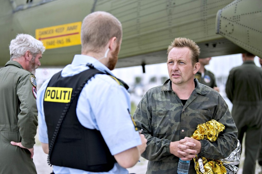 Peter Madsen (right) talks to police in Copenhagen. Photo: AFP