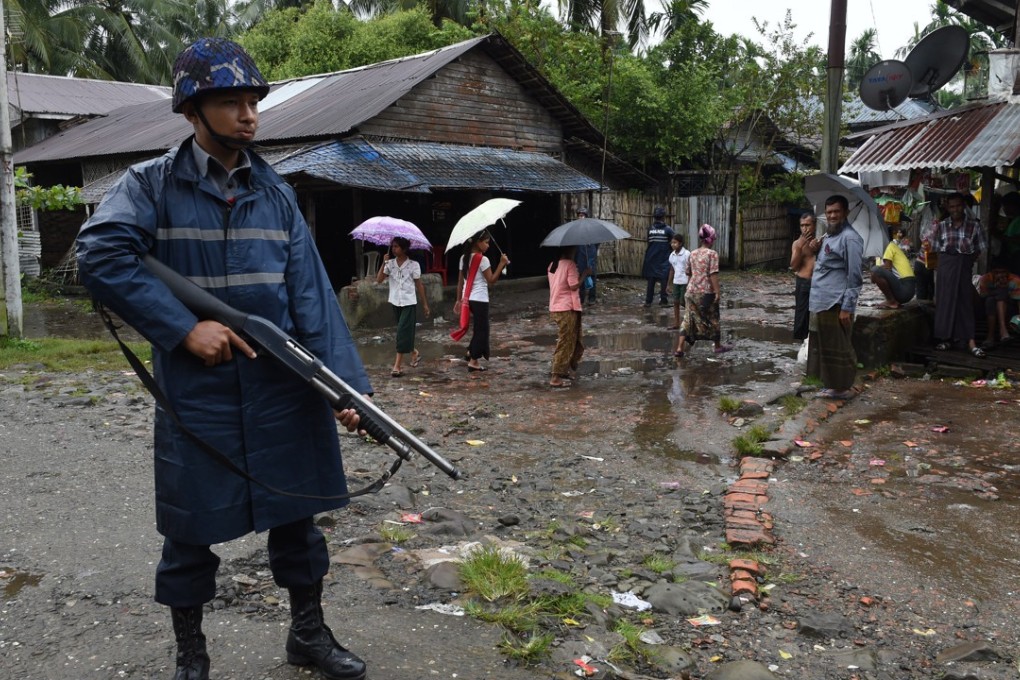 An armed policeman on guard at a displacement camp for the minority Muslim Rohingya in Myanmar’s Rakhine State. Picture: AFP
