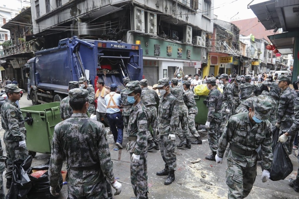 The Chinese Army helps Macau residents with the recovery effort after Typhoon Hato hit the city. Photo: Edward Wong