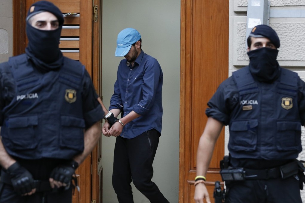 Catalan autonomous police officers detain a cuffed suspect in Ripoll during a search linked to the deadly terror attacks in Barcelona and the seaside resort of Cambrils on August 18. Photo: AFP