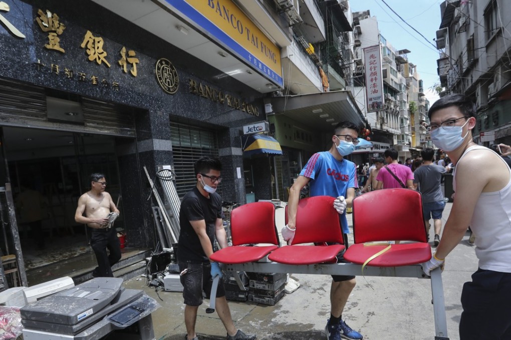 Residents of Macau help clear and recover damaged or lost goods after Typhoon Hato hit on Wednesday. Photo: Edward Wong