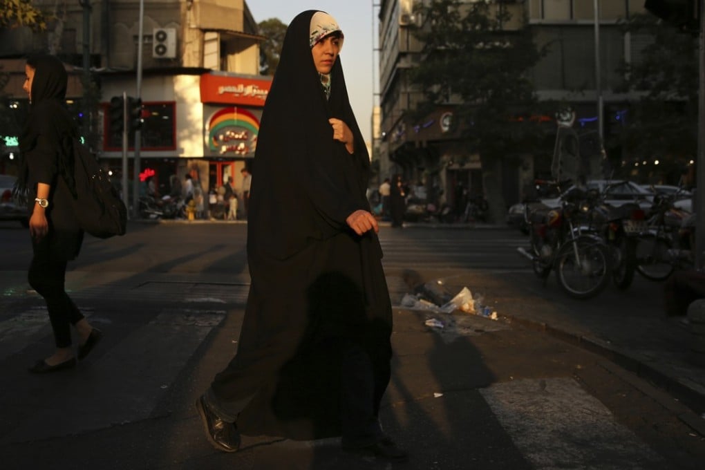 A woman wearing the chador in downtown Tehran, Iran. Photo: AP