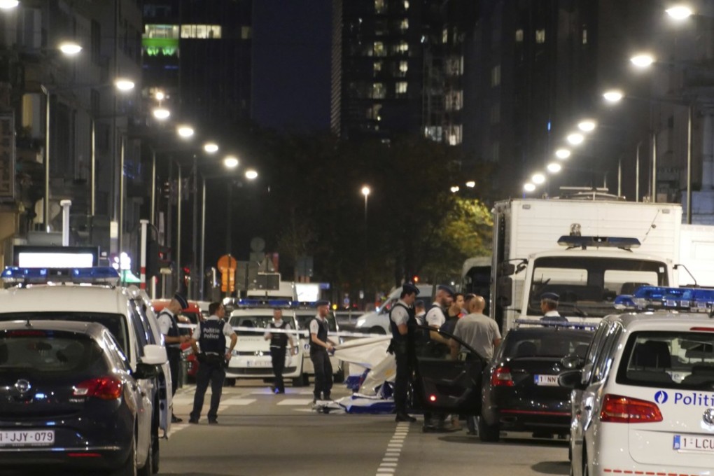Police secure the scene in downtown Brussels after a reported attack on Belgian soldiers. Photo: AP
