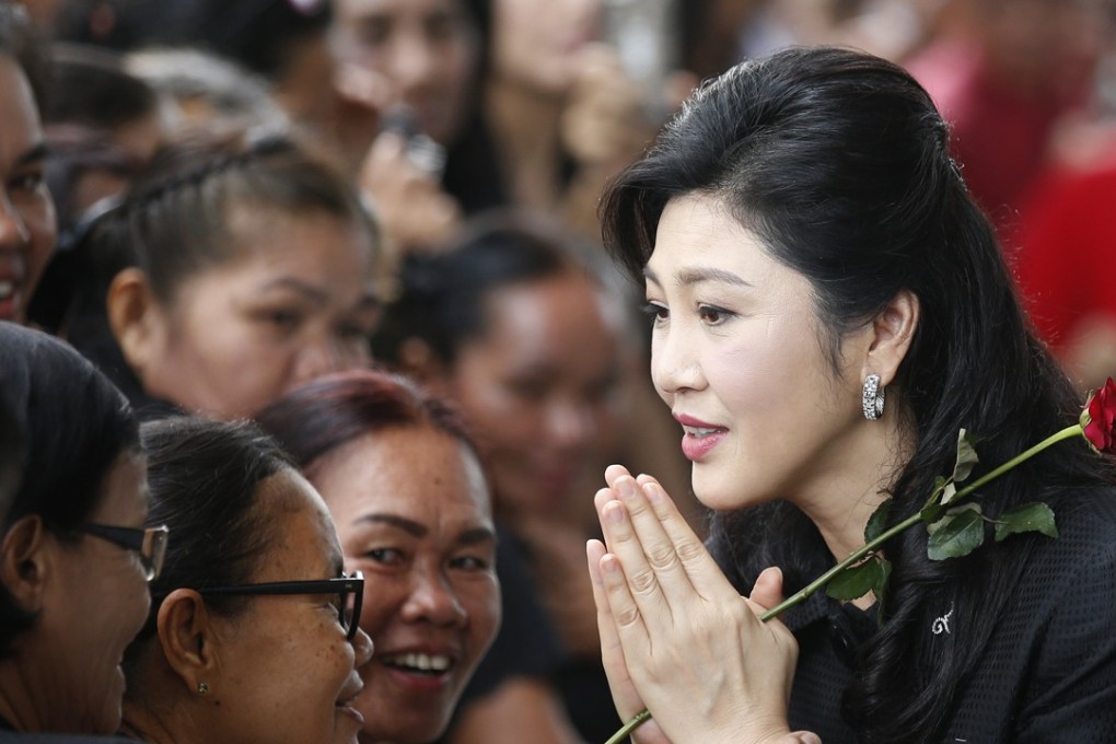 Former Thai Prime Minister Yingluck Shinawatra greets supporters. Photo: EPA