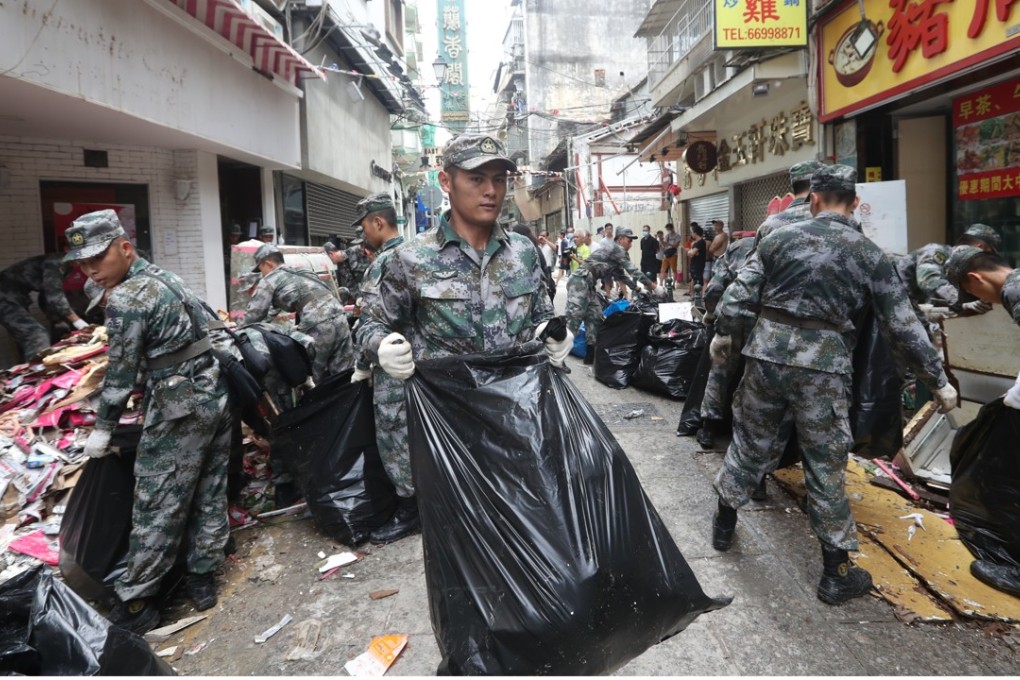 The Chinese Army helps Macau residents with the recovery effort after Typhoon Hato hit the city. Photo: Edward Wong