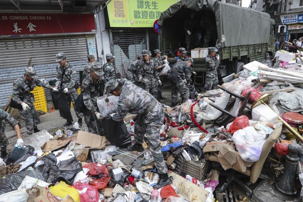 PLA soldiers clear the streets of debris in Macau. Photo: Edward Wong
