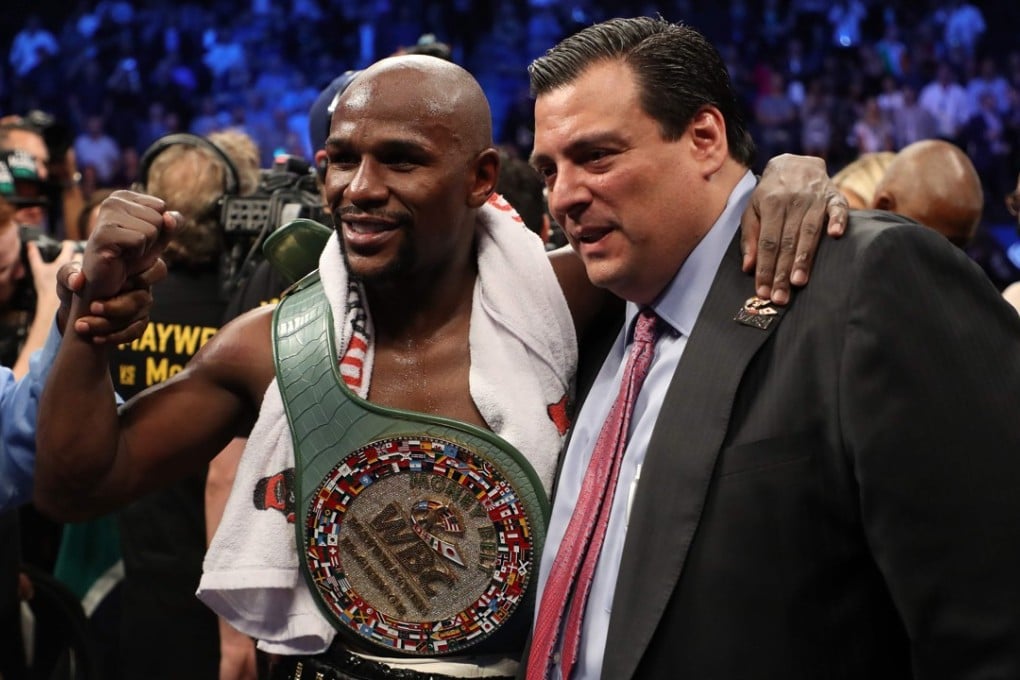 Floyd Mayweather celebrates with WBC president Mauricio Sulaiman. Photo: AFP