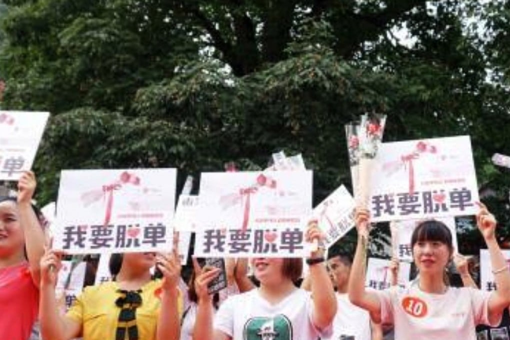 The group of singles parade in front of the tree carrying banners. Photo: Handout