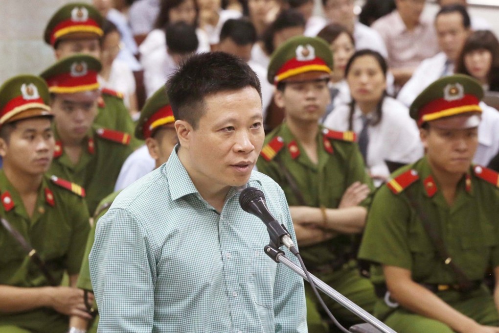 Former Ocean Bank chairman Ha Van Tham, 44, stands trial at the People's Court in Hanoi. Photo: AFP
