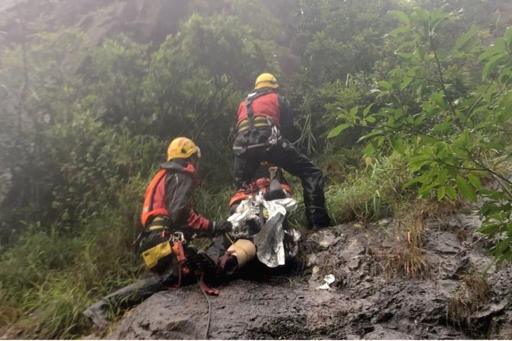 Rescue workers carry the injured woman up Kowloon Peak on Sunday morning. Photo: Handout