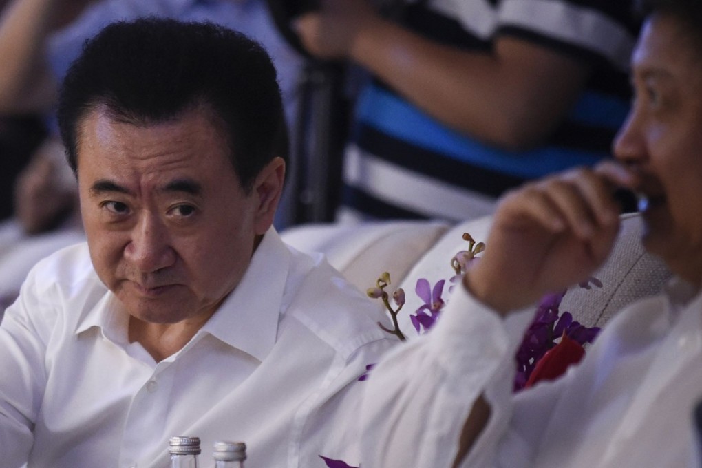 Wang Jianlin (left) attends the signing ceremony for a strategic partnership between Wanda Group, Sunac and R&F Properties Group in Beijing on July 19. Photo: AFP