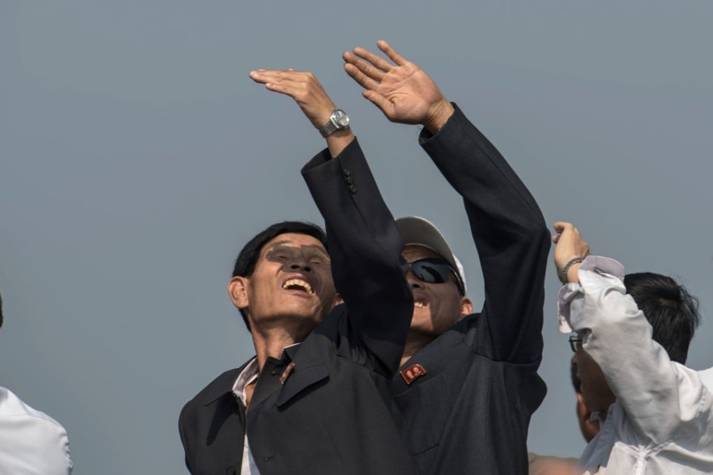 Spectators watch helicopters perform a fly-by during the 2016 first Wonsan Friendship Air Festival in Wonsan. File photo: AFP