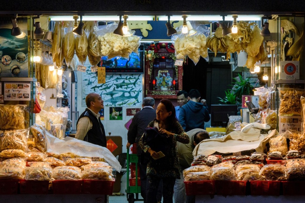 A shop selling shark fin products in Hong Kong, with a poster inside describing the various species. Photo: AFP