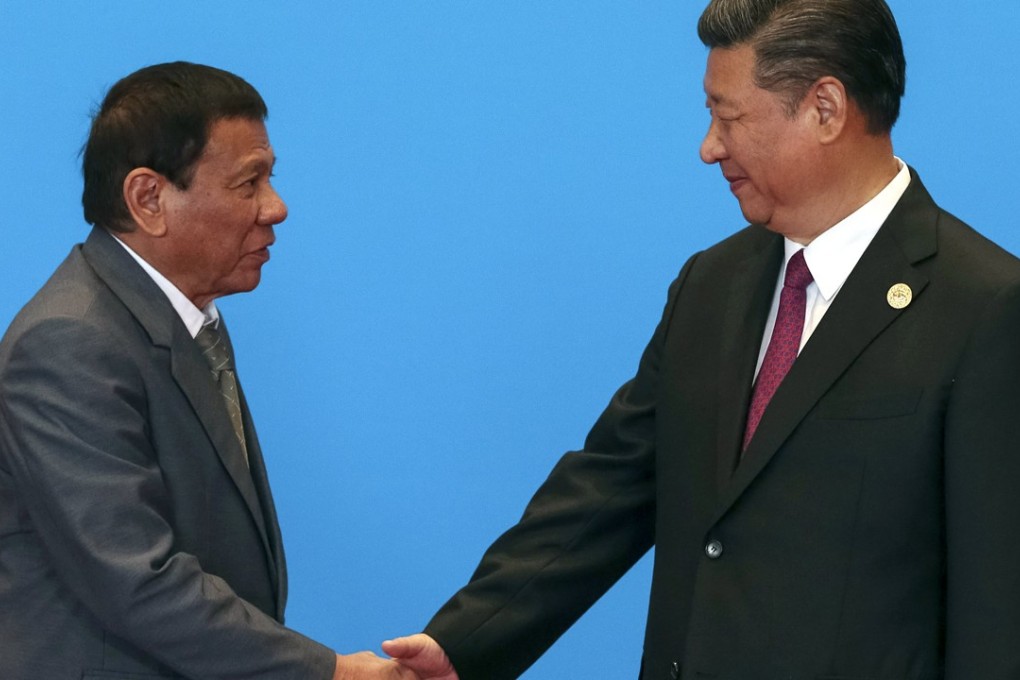 President Xi Jinping, right, shakes hands with Philippines President Rodrigo Duterte as they attend the welcome ceremony at Yanqi Lake during the Belt and Road Forum, in Beijing in May. Photo: EPA