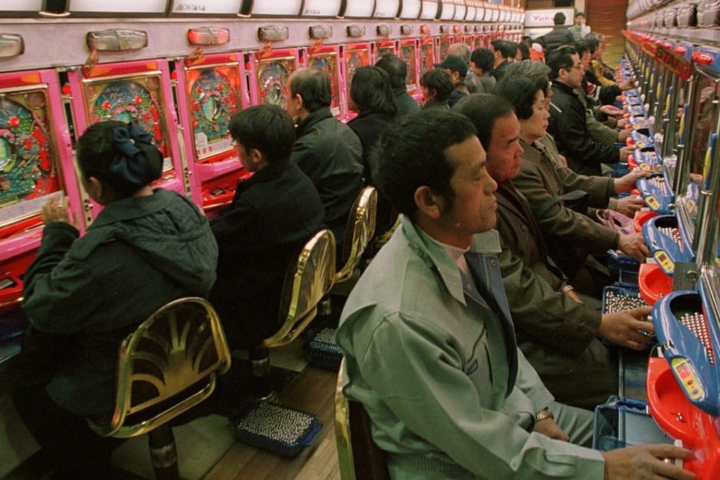 Pachinko players in one of Tokyo’s many downtown parlours. Photo: AP