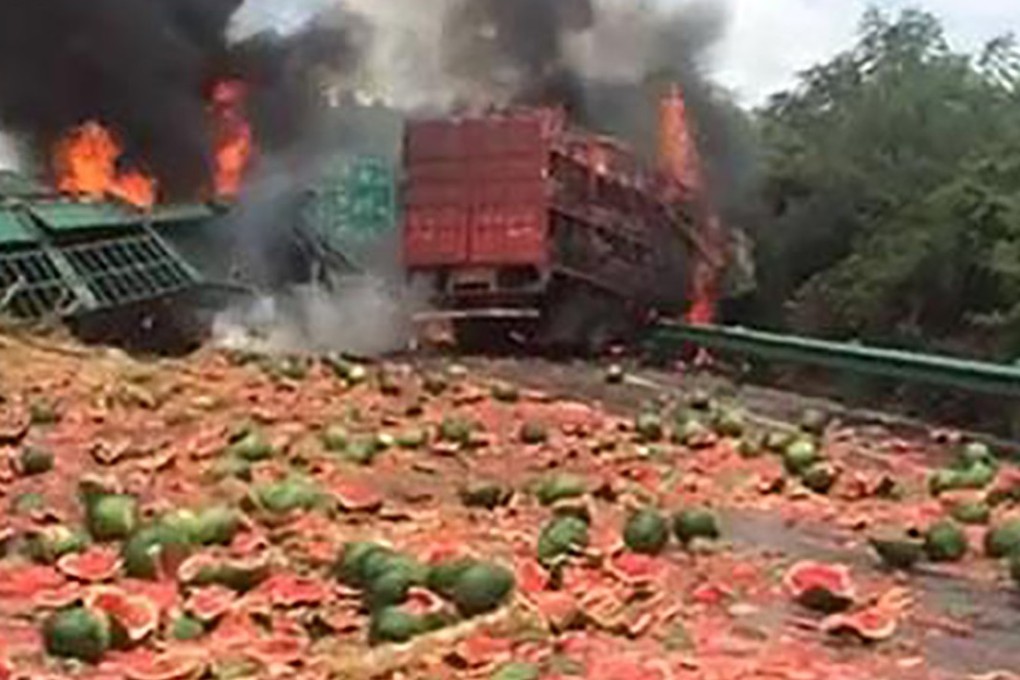 A fatal truck crash in Hunan left both vehicles in flames and a load of watermelons strewn across an expressway on Monday. Photo: Handout