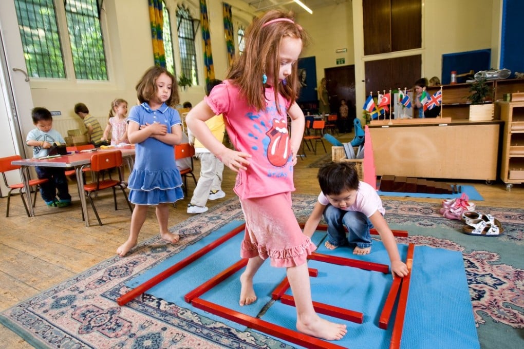 Children enjoy educational play at a Paint Pots Montessori School in London. Picture: Alamy