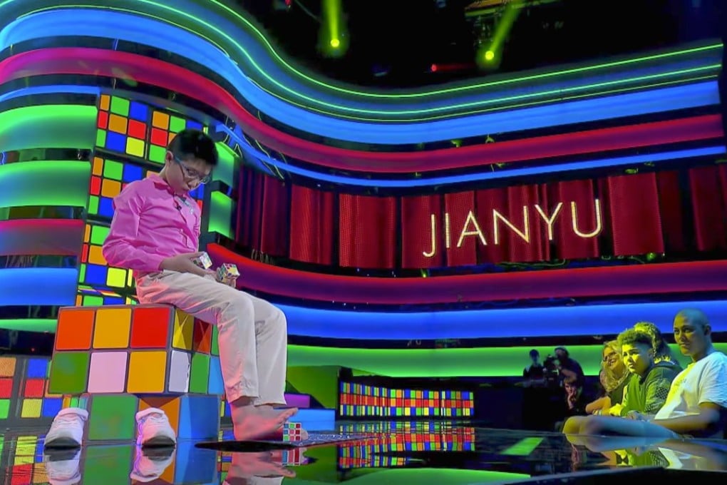 Que Jianyu woking on three Rubik’s cubes with his hands and feet. Photo: Handout