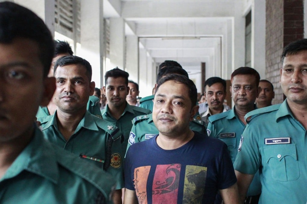 Bangladeshi security personnel escort Sohel Rana after a court appearance in Dhaka. Photo: AFP