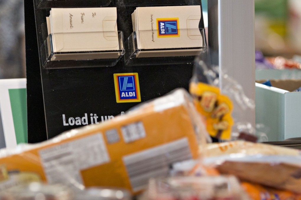 Gift cards on display near a check out at an Aldi Store. The German chain is known for low prices on its private-label items, and it now plans to spend US$3.4 billion over the next five years to open 900 supermarkets, the company said in June. Photographer: Daniel Acker/Bloomberg