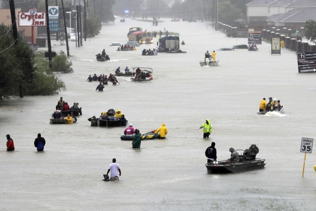 Rescue boats fill a flooded street in Houston, Texas. Photo: AP