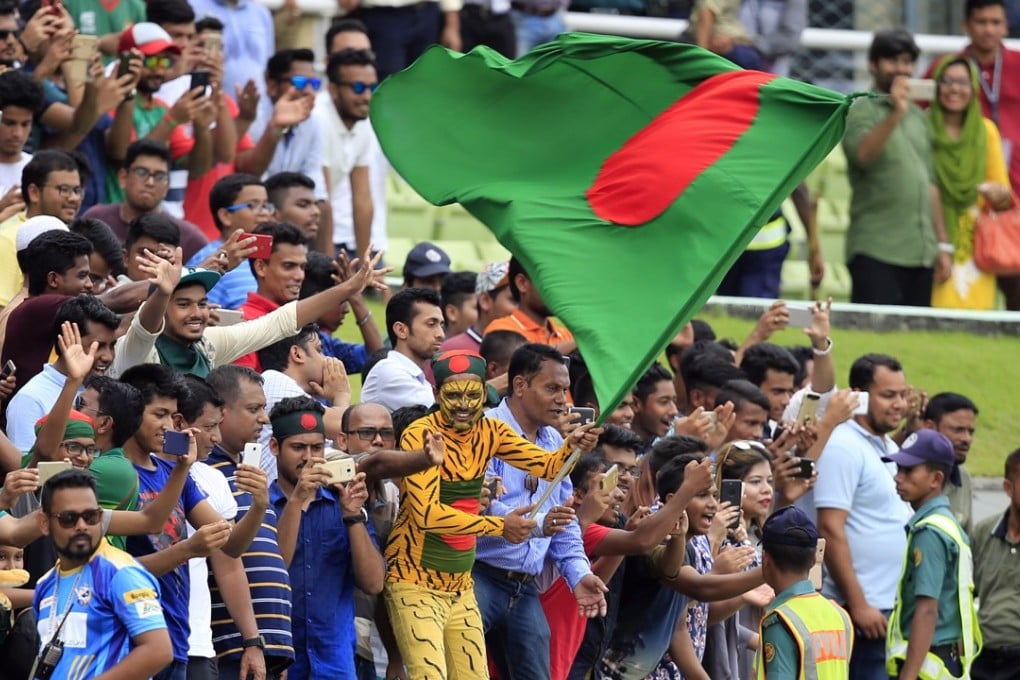Bangladeshi spectators celebrate their team's victory over Australia in Dhaka, Photos: AP