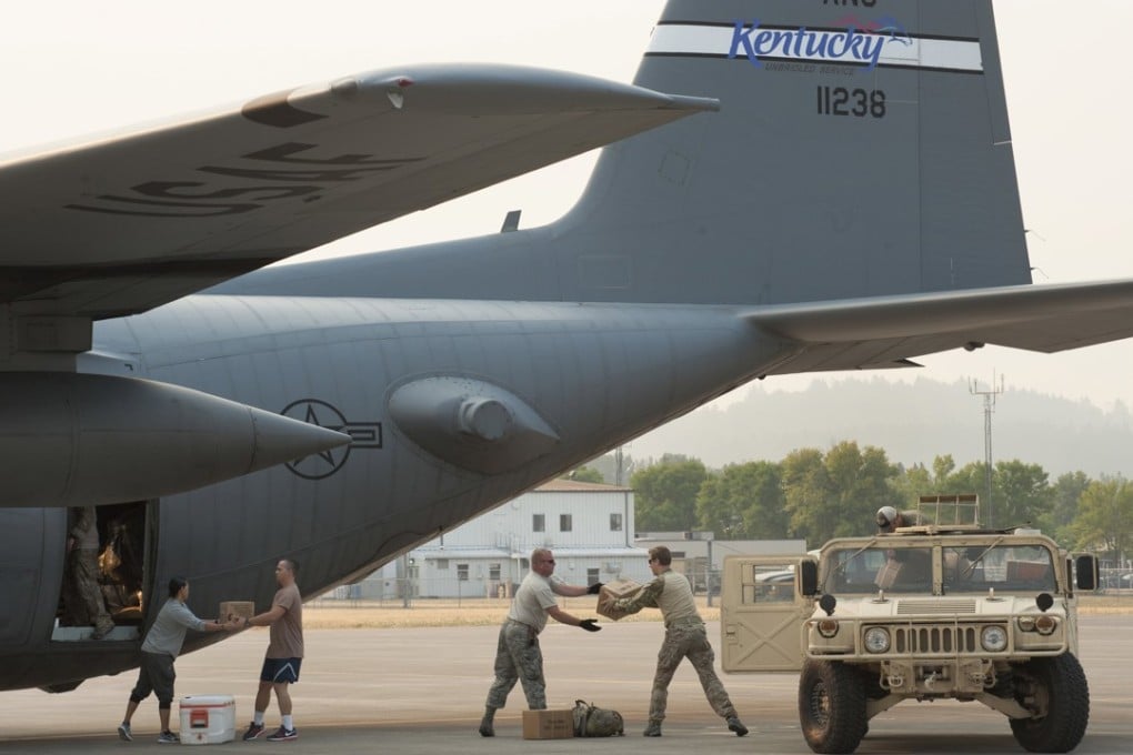 Airmen board a US Air National Guard C-130 Hercules with equipment and supplies to support Hurricane Harvey relief efforts. Photo: EPA