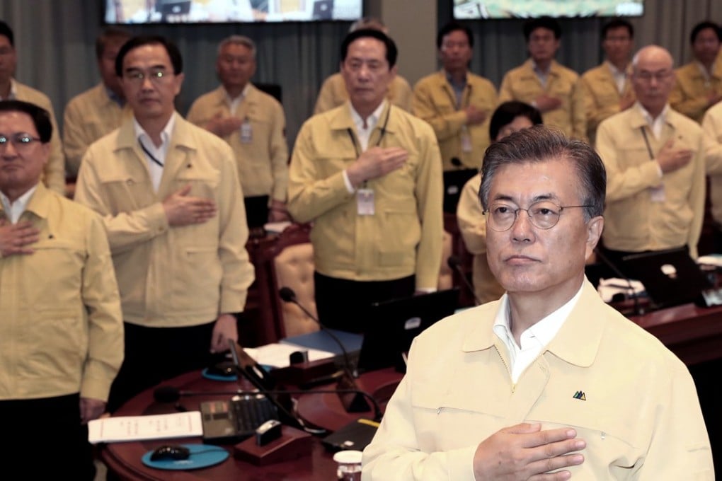 South Korean President Moon Jae-in salutes the national flag during a cabinet meeting at the presidential Blue House, in Seoul on August 21. Photo: AP