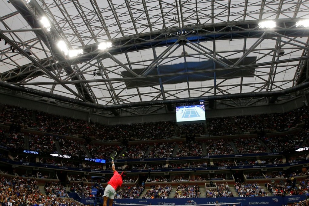 Rafael Nadal serves to Serbia’s Dusan Lajovic under the roof on Arthur Ashe stadium. Photo: AFP
