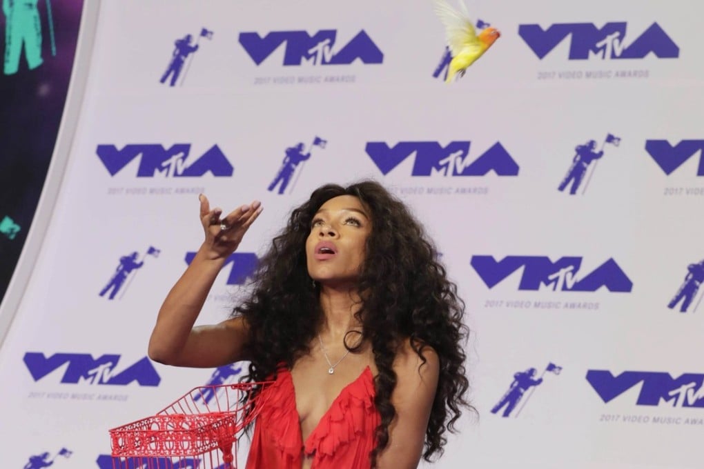 US rapper Lil Mama releases a bird from a cage on the red carpet at the MTV Video Music Awards. Picture: EPA