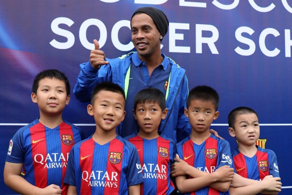 Ronaldinho (centre) during a trip in February to launch Barcelona’s Mission Hills academy on the southern Chinese island of Hainan. Photo: AFP
