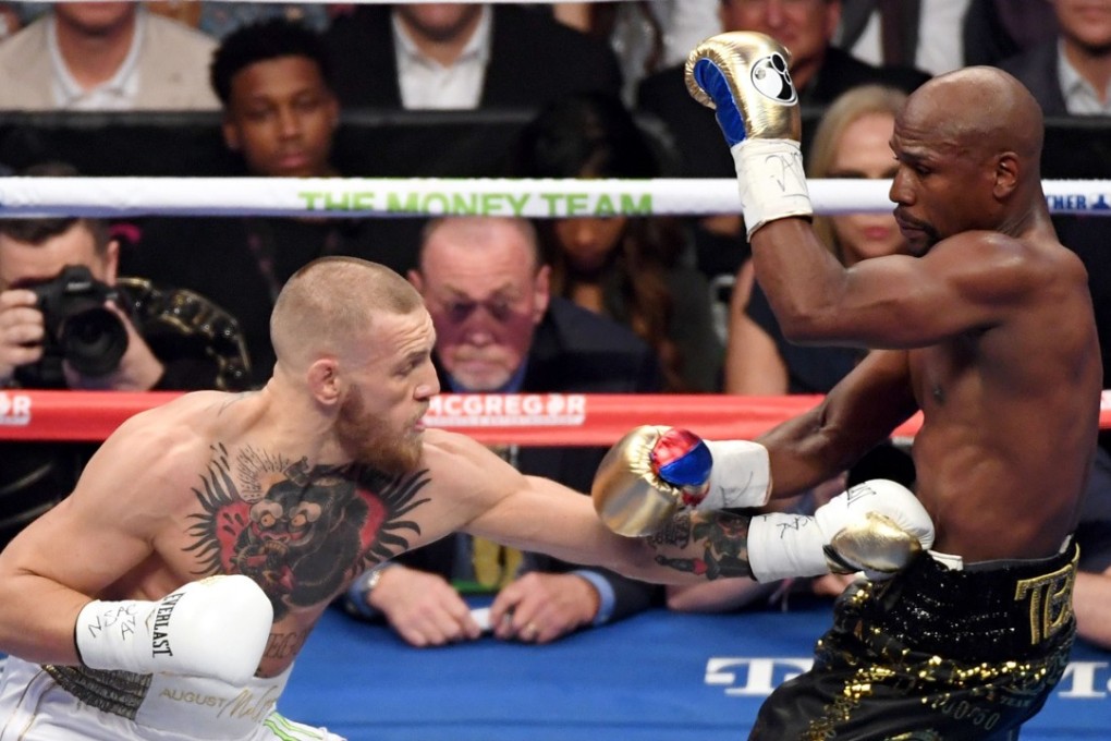 Floyd Mayweather Jnr (right) secured a 10th-round TKO victory against Conor McGregor. Photo: AFP