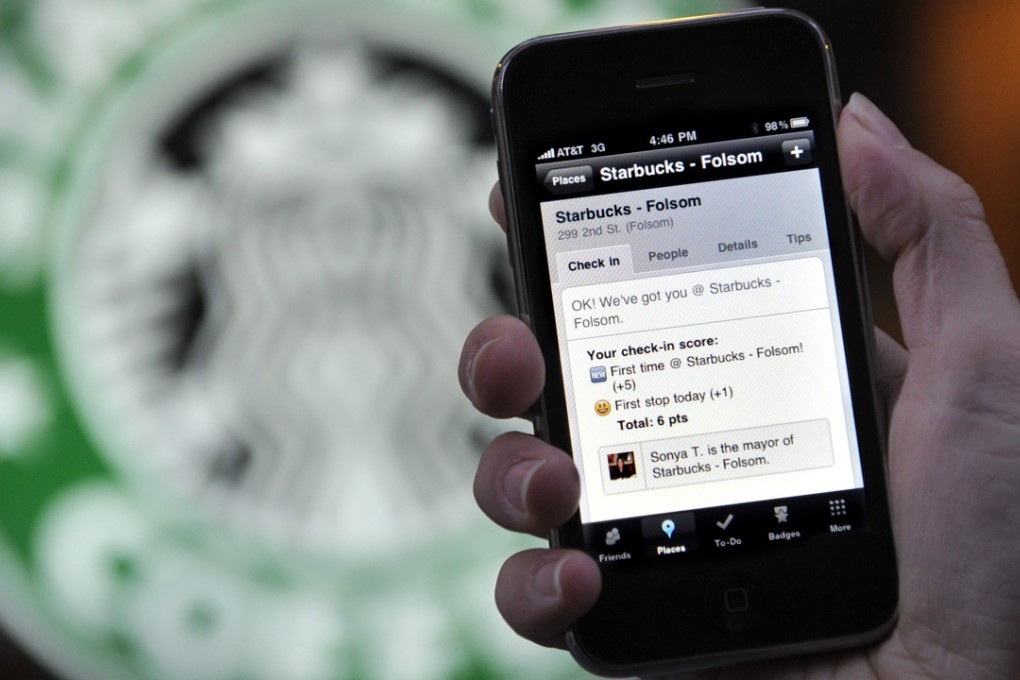 The Foursquare application on an iPhone in front of a Starbucks in San Francisco. Photo: AP/Russel A. Daniels