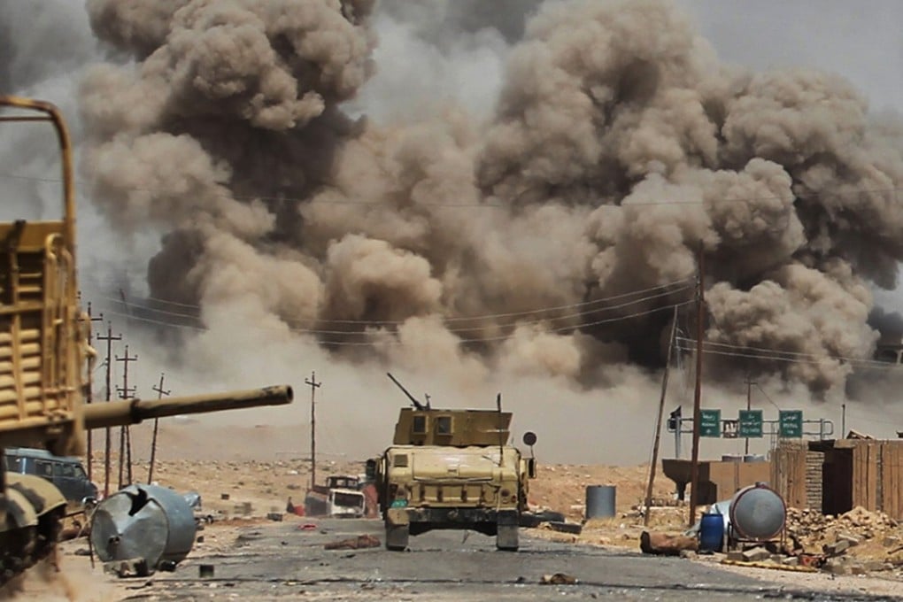 Smoke billows as Iraqi forces advance towards Al-Ayadieh village, the last remaining active front line near Tal Afar, during an operation to retake the city from the Islamic State (IS) group. Photo: AFP